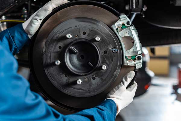 technician replacing brakes